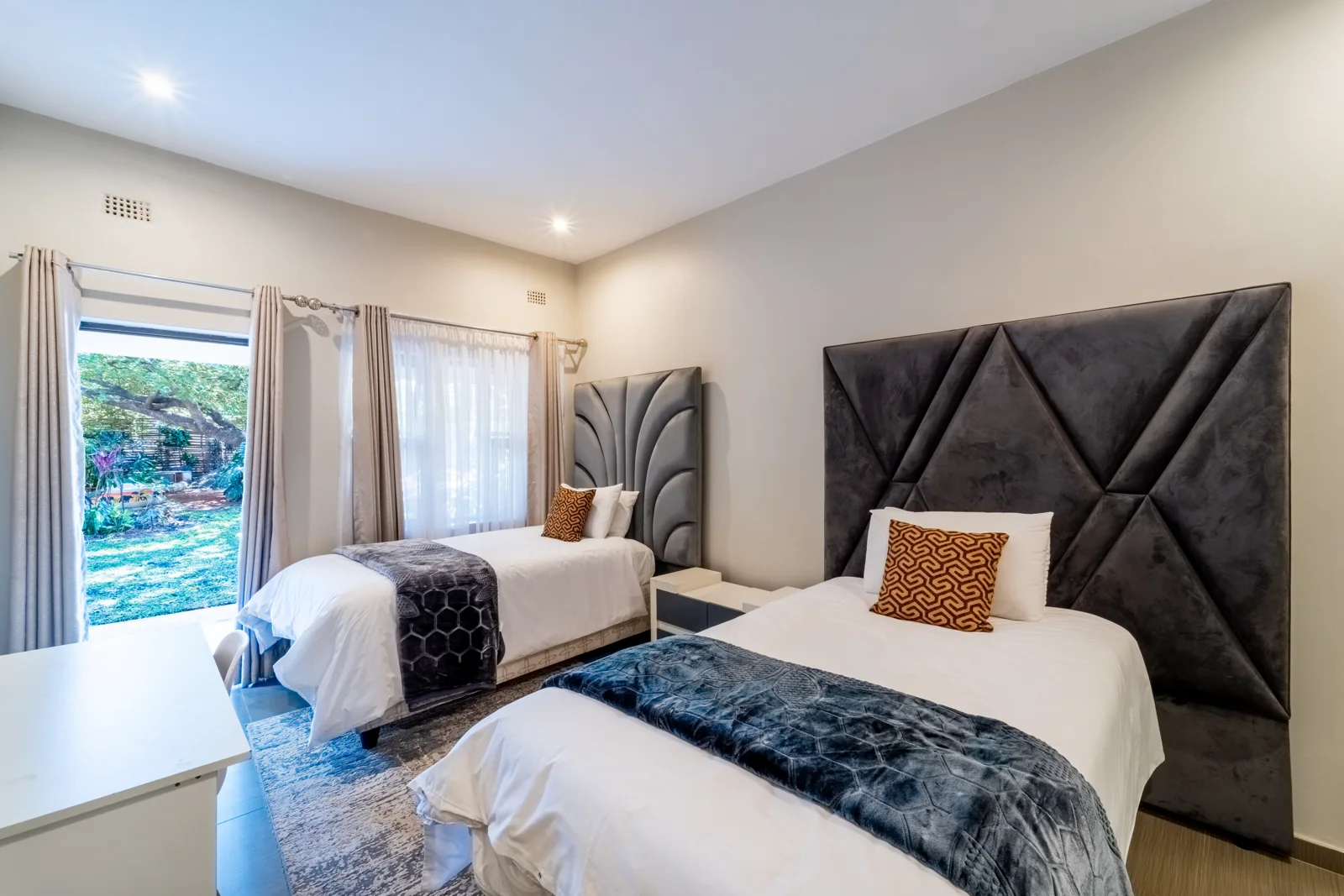 Twin Bedroom 1 with two single beds and a garden entrance