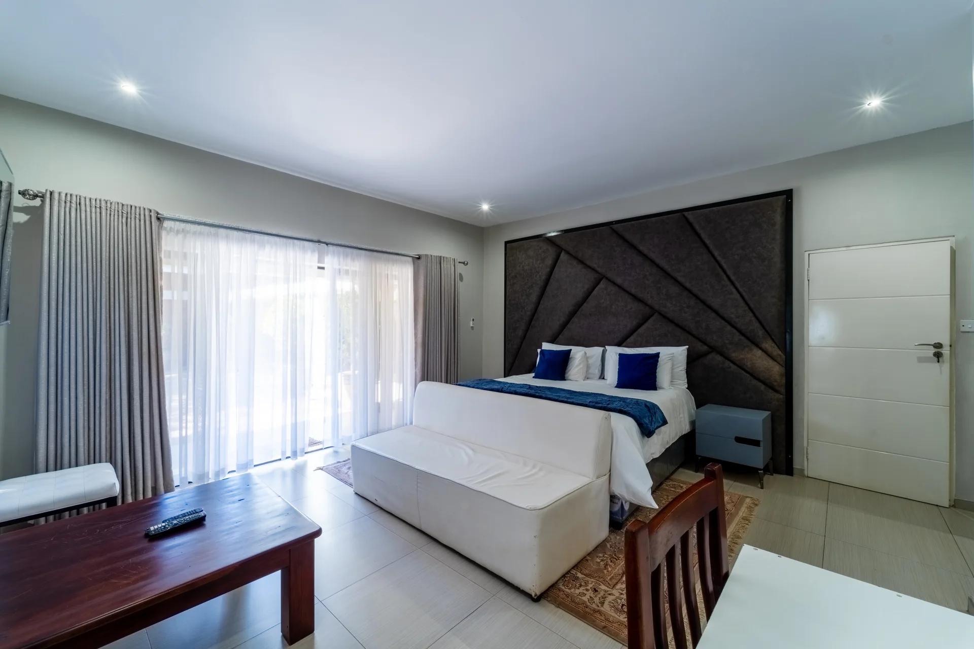 King Room with Garden View, blue accents and a generous sitting area